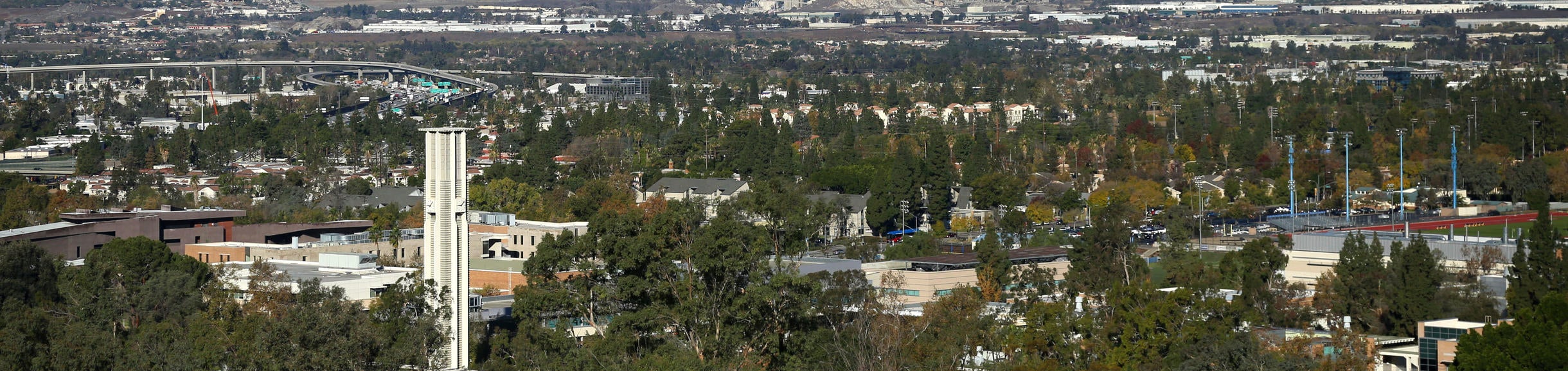 UCR Bell Tower seen from a distance with snowy mountains in the background